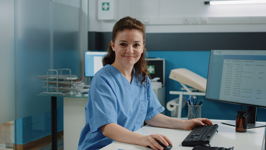 Nurse using computer for appointments.