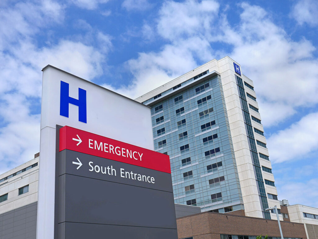 A generic hospital sign directing traffic to the different areas of the hospital.