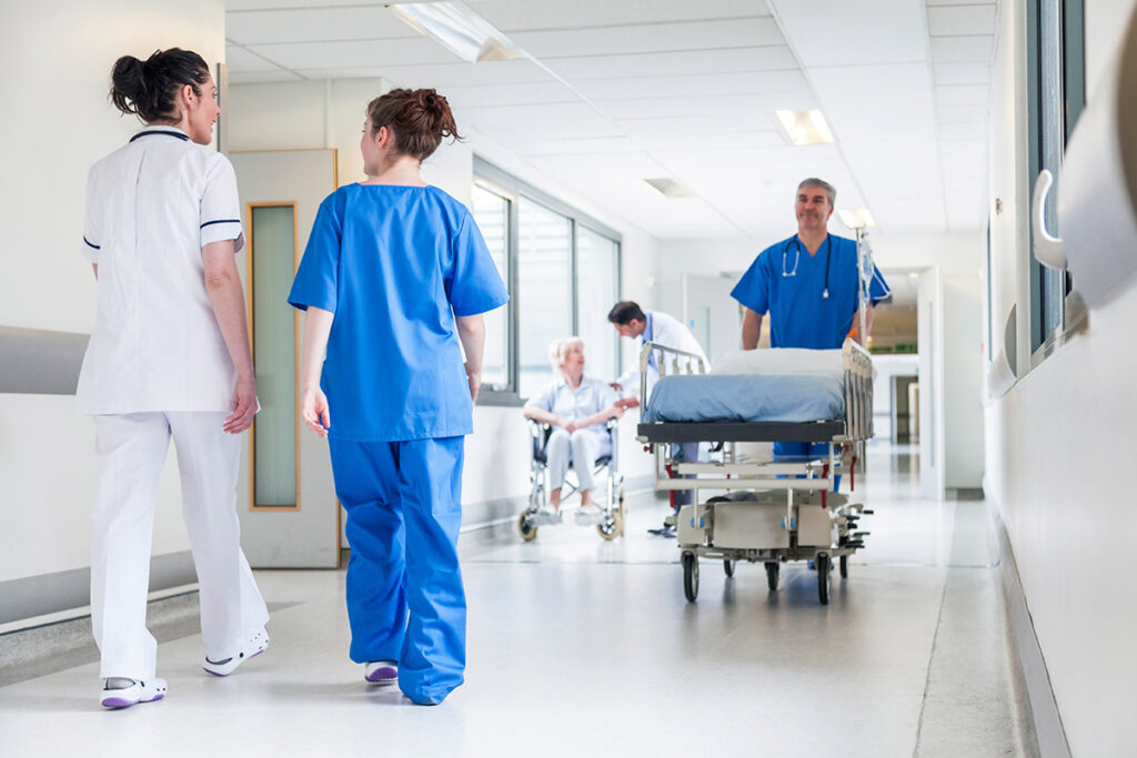 Nurses moving down a hospital corridor.