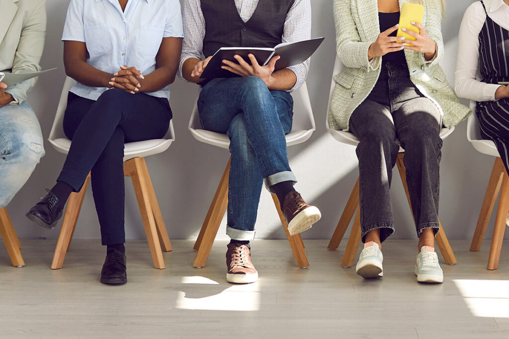 A diverse group of people waiting at a recruitment agency.