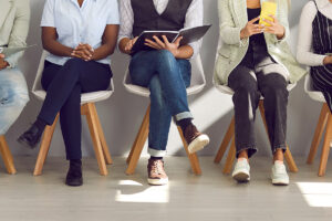 A diverse group of people waiting at a recruitment agency.